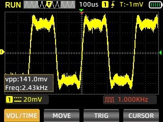The image displays an oscilloscope reading, showing a yellow waveform with a vertical peak-to-peak voltage (vpp) of 141.0 mV and a frequency of 2.43 kHz. The time division is set to 